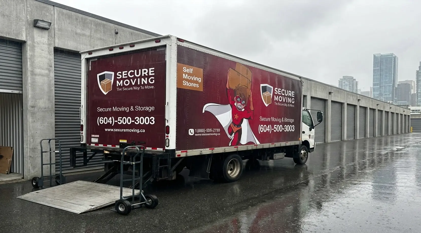 Moving truck parked by rows of roll-up units at a facility offering storage space vancouver bc and affordable storage Vancouver.