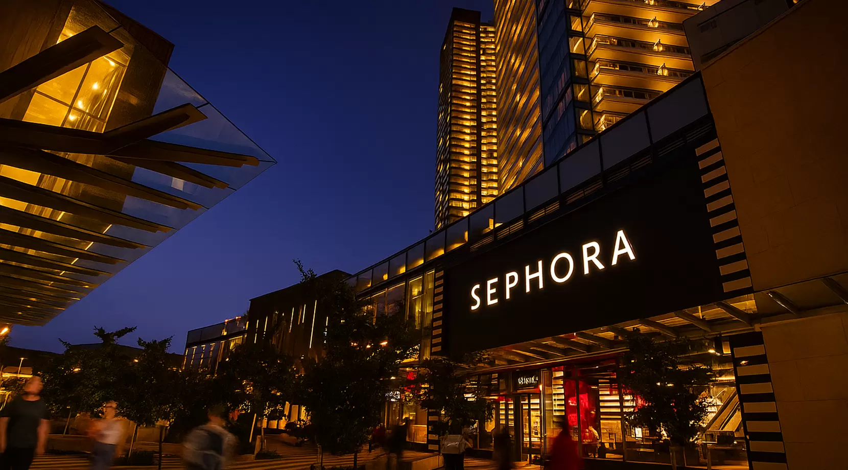 Brentwood plaza at dusk with illuminated towers and walkways. Movers guide a dolly to a loading bay. The Secure Moving logo appears on an elevator pad, crisp, placed for work.