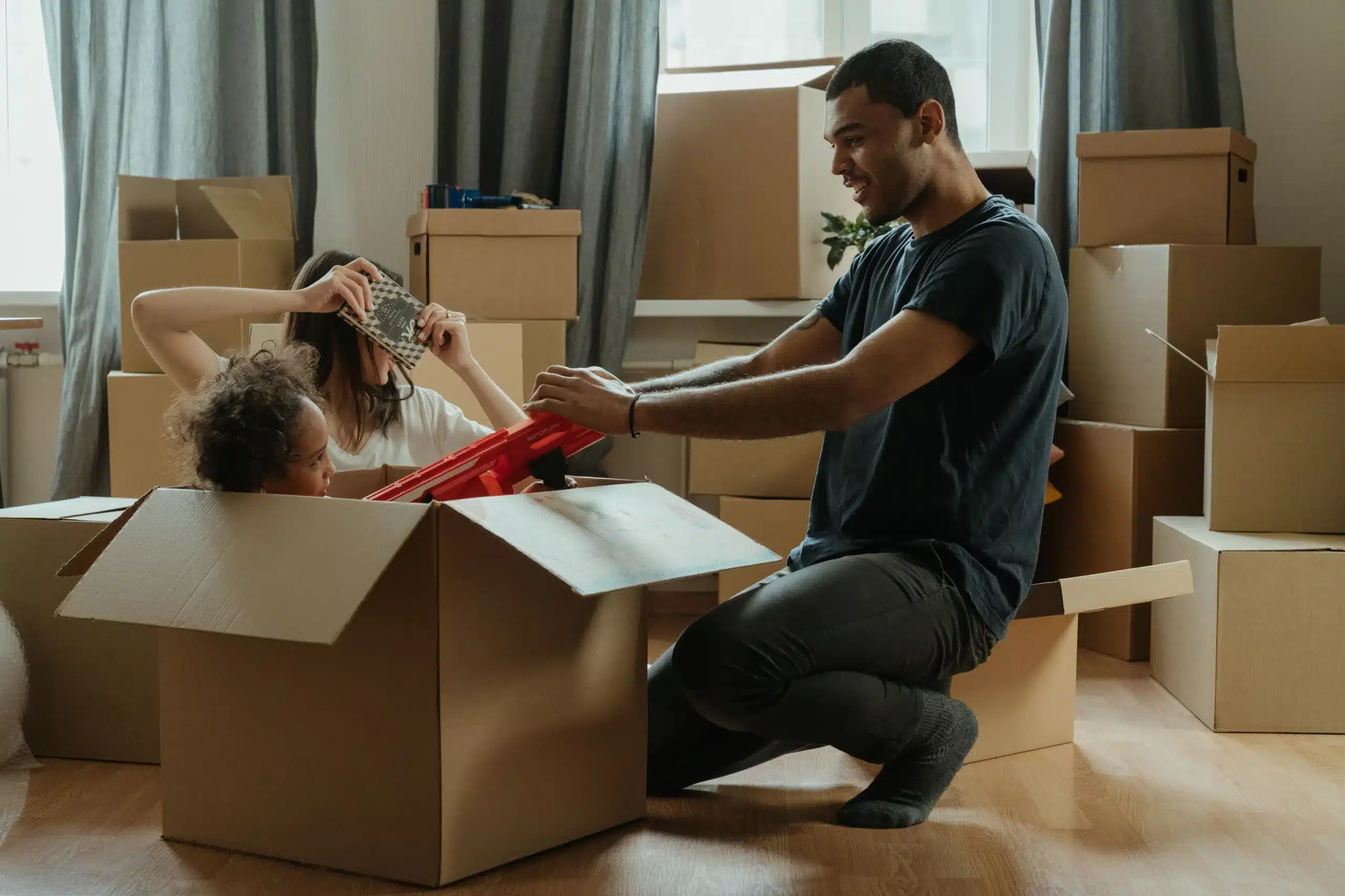 A family packing boxes for a move